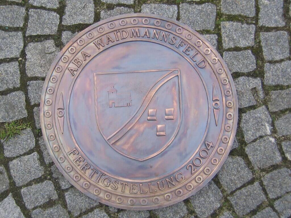 Bodeneinlegeplatte aus Bronzeguss mit Wappen der ABA Waidmansfeld